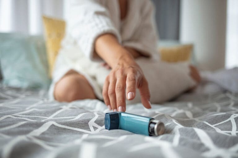 A lady reaching for an inhaler