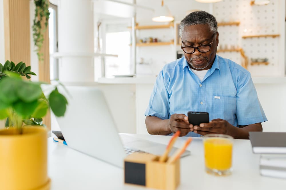 Elderly man using a phone