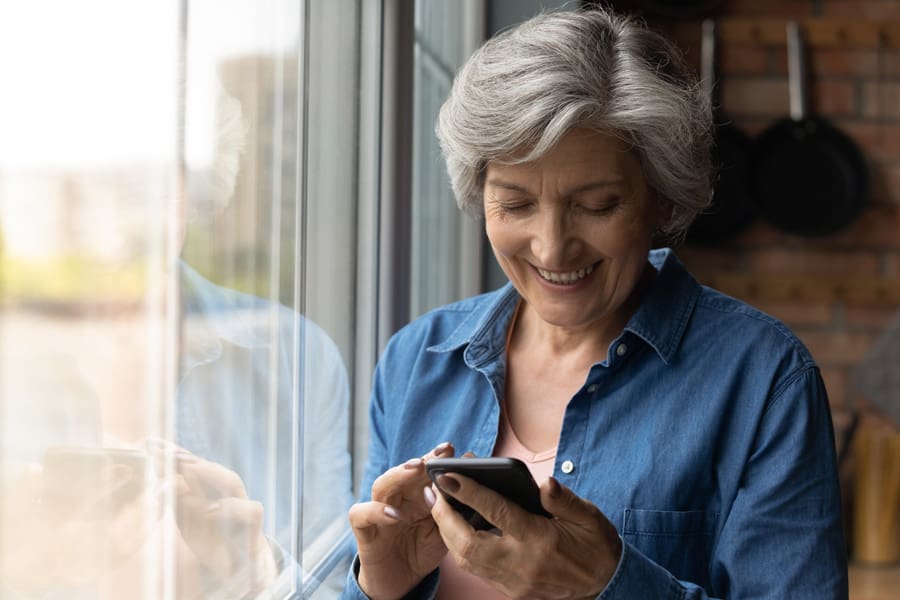 Lady smiling at her mobile